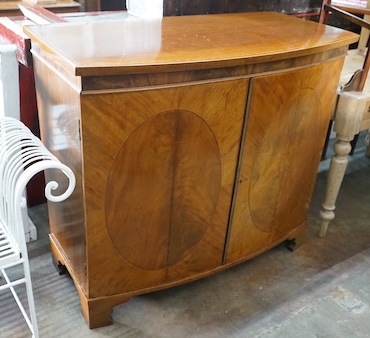 An Edwardian Sheraton revival satinwood banded mahogany bowfront two door side cabinet, width 106cm, depth 53cm, height 95cm